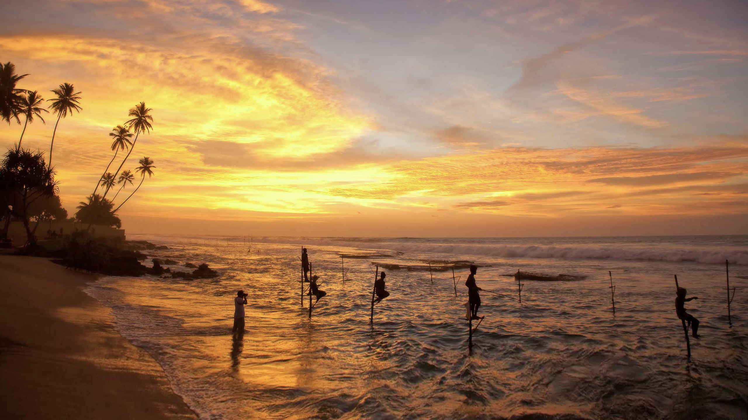 Traditional stilt fishing at sunset in Sri Lanka